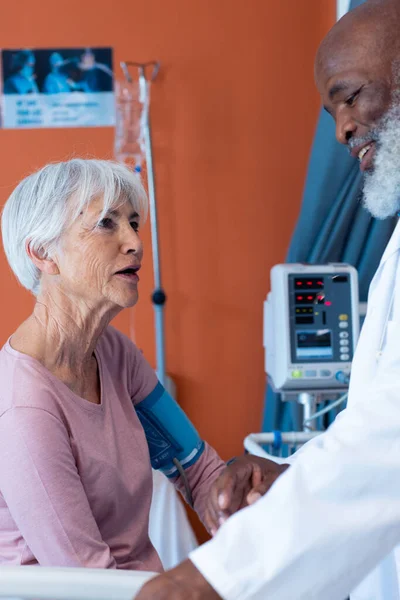 Vertical Happy Diverse Senior Male Doctor Taking Blood Pressure Female — Photo
