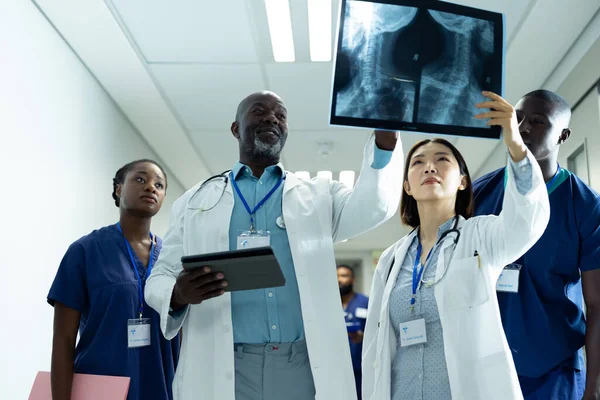 Grupo Diverso Quatro Médicos Profissionais Saúde Que Estudam Radiografia Corredor — Fotografia de Stock