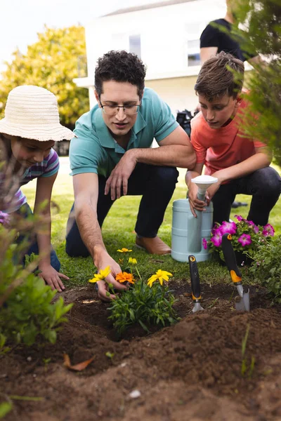 Caucasian family spending time together in the garden, planting. Family time spending outside , garden, gardening, concept.