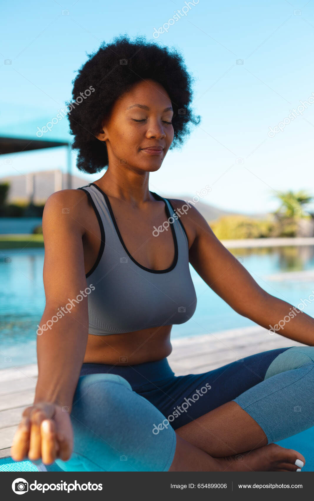 Young Afro African American Woman Meditating Poolside Copy Space