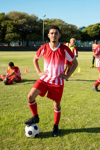 Confident Multiracial Young Player Uniform Arms Akimbo Leg Soccer Ball — Stock Photo, Image