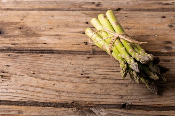 stock image Close-up of asparagus tied with thread on wooden table, copy space. Unaltered, food, vegetable, fresh, raw food.