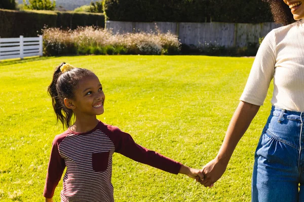 Midsection Biracial Mother Holding Happy Daughter Hands While Standing Field — Stock Photo, Image
