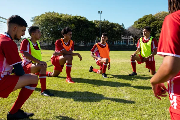 Multiracial Male Soccer Team Players Stretching Legs Grassy Field Playground — Stock Photo, Image