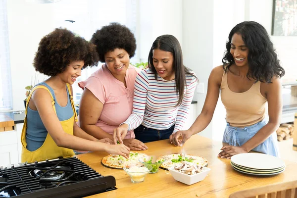 Biracial Millennial Female Friends Preparing Pizzas Kitchen Island While Spending — Stock Photo, Image