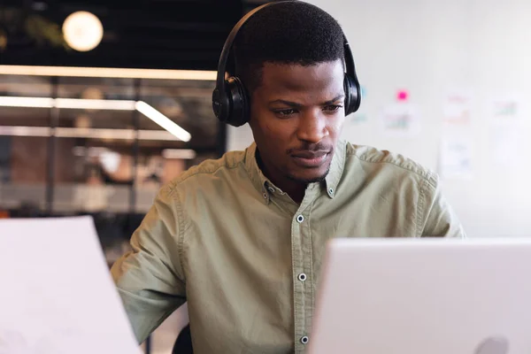 Jovem Empresário Afro Americano Com Fones Ouvido Usando Laptop Escritório — Fotografia de Stock