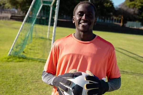 Portrait Smiling African American Young Male Goalkeeper Wearing Gloves Holding — Stock Photo, Image