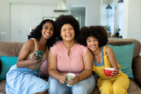 Portrait Cheerful Biracial Young Female Friends Holding Coffee Cups Relaxing — Stock Photo, Image