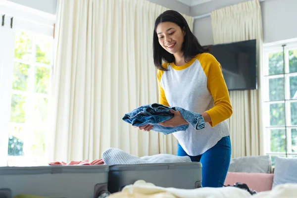 Smiling Biracial Woman Packing Suitcase Holiday Bedroom Copy Space Free — Stock Photo, Image