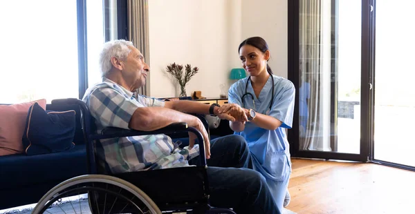 車椅子に座っている白人の老人をサポートする出産女性の健康労働者 医療と定年退職シニアライフスタイルの概念 — ストック写真
