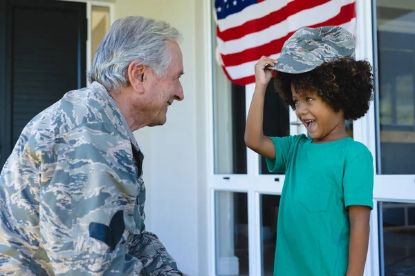 Caucasian Military Grandfather Looking Cheerful Biracial Boy Wearing Camouflage Cap — Stock Photo, Image