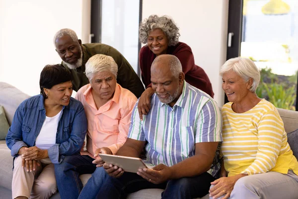 Multirazziale Anziani Curiosi Guardando Amico Maschio Utilizzando Tablet Digitale Mentre — Foto Stock