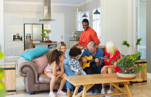 多种族老人在沙发上与快乐的多代家庭一起弹奏吉他 不变的家庭 业余爱好 生活方式和家庭观念 — 图库照片