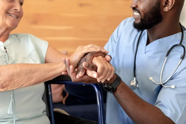African American Male Health Worker Supporting Caucasian Senior Woman Sitting — Stock Photo, Image