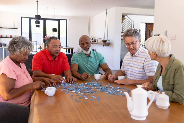 Multiracial Senior Friends Coffee Cups Table Solving Jigsaw Puzzle Nursing — Stock Photo, Image