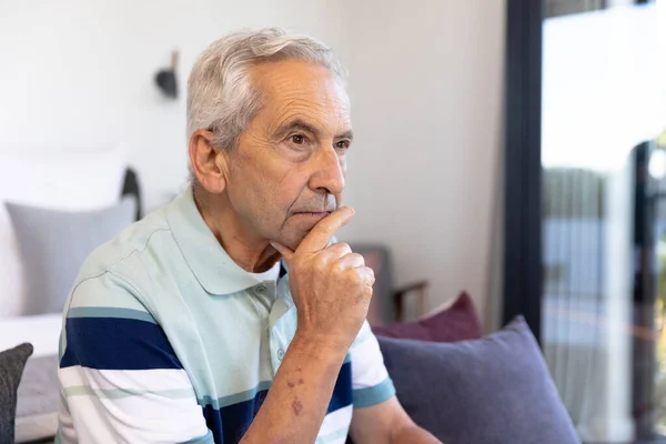 Thoughtful Caucasian Senior Man Hand Chin Looking Away While Sitting — Stock Photo, Image