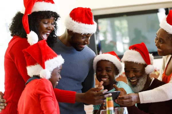 Multi Generation African American Family Smiling Wearing Santa Hats Using — Stock Photo, Image