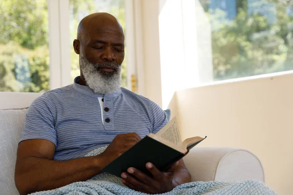 Kıdemli Afro Amerikan Adam Evde Oturuyor Kanepede Oturuyor Kitap Okuyor — Stok fotoğraf