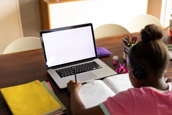 アフリカ系アメリカ人の女の子は自宅のノートパソコンを使って学校の仕事をしている画面上のスペースをコピーします 子供時代 オンライン学習 家庭生活 — ストック写真
