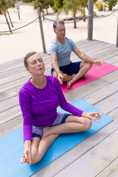 Avslappnad Kaukasisk Senior Par Praktiserar Yoga Meditation Sitter Soligt Stranddäck — Stockfoto