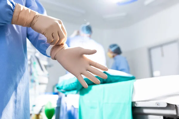 Midsection Surgeon Putting Surgical Gloves Operating Theatre Copy Space Surgery — Stock Photo, Image