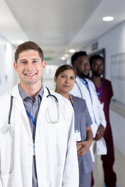 Unaltered Portrait Smiling Caucasian Male Doctor Diverse Colleagues Hospital Corridor — Stock Photo, Image