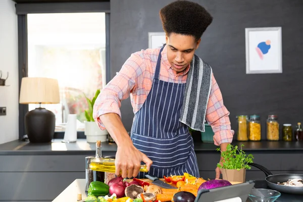 Biracial Man Wearing Apron Cooking Dinner Pouring Vegetables Oil Kitchen — Stock Photo, Image