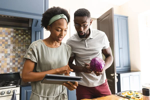 幸せなアフリカ系アメリカ人のカップル一緒に台所でタブレットを使用して食事を準備 健康的なライフスタイル レシピ コミュニケーション 一緒に 食品や国内生活 変更なし — ストック写真