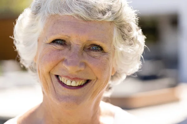 stock image Portrait of happy senior caucasian woman looking at camera and smiling in sunny garden. Retirement, health, relaxation and senior lifestyle, unaltered.
