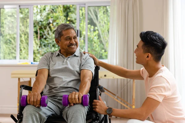 Счастливый Мужчина Физиотерапевт Пожилой Мужчина Пациент Инвалидной Коляске Гантелями Физиотерапия — стоковое фото