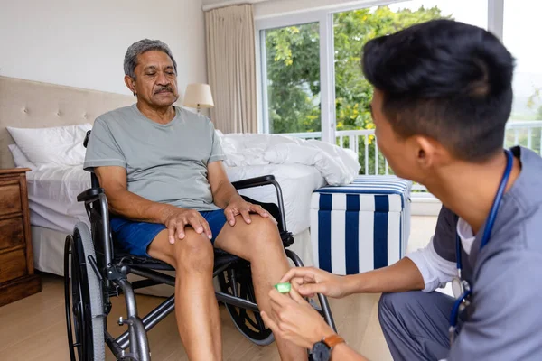 Diverse Male Doctor Discussing Medication Senior Male Patient Wheelchair Home — Stock Photo, Image
