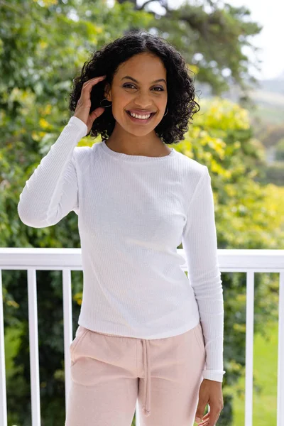 Portrait Smiling Biracial Woman Standing Sunny Balcony Home Front Treetops — Stock Photo, Image