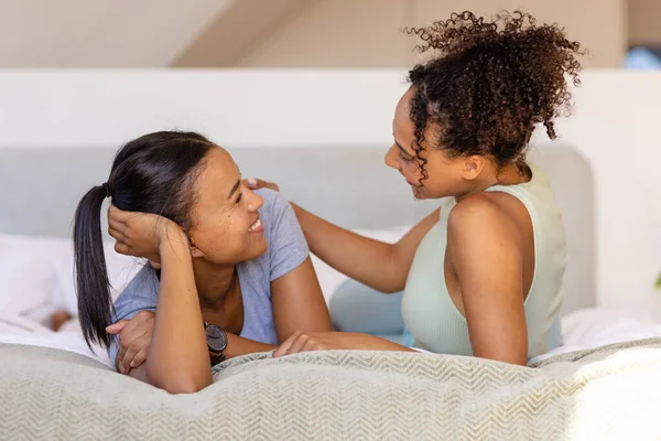 Happy Biracial Lesbian Couple Embracing Talking Bed Bedroom Relaxation Lifestyle — Stock Photo, Image