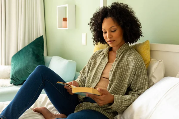 美丽的女人躺在明亮的卧室里看书 生活方式和家庭生活 — 图库照片
