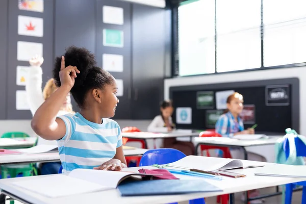 African American Schoolgirl Sitting Desk Raising Hand Elementary School Classroom — Stock Photo, Image