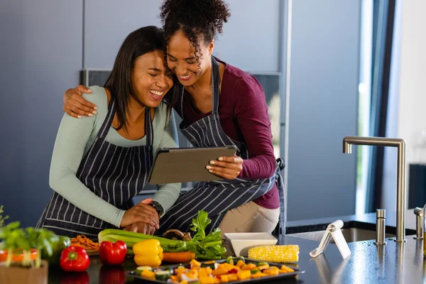 Happy Biracial Lesbian Couple Preparing Meal Using Tablet Kitchen Cooking — Stock Photo, Image