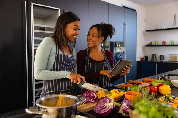Happy Biracial Lesbian Couple Chopping Vegetables Using Tablet Kitchen Cooking — Stock Photo, Image