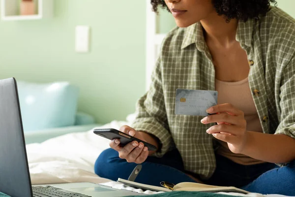 Mid Section Biracial Woman Using Laptop Smartphone Credit Card Bed — Stock Photo, Image