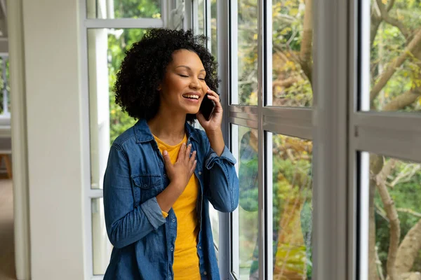 Happy Biracial Woman Talking Smartphone Looking Out Window Home Lifestyle — Stock Photo, Image