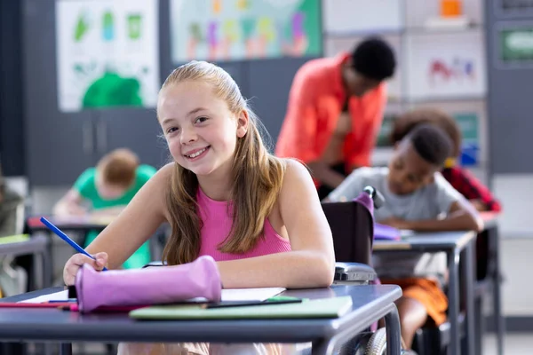 Portrait Smiling Caucasian Schoolgirl Sitting Desk Working Class Education Inclusivity — Stock Photo, Image