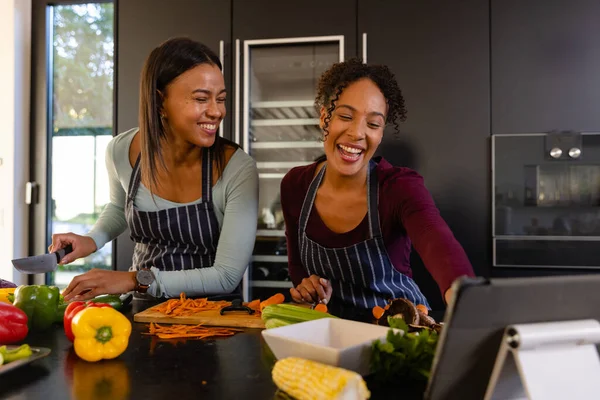 Happy Biracial Lesbian Couple Chopping Vegetables Using Tablet Kitchen Cooking — Stock Photo, Image