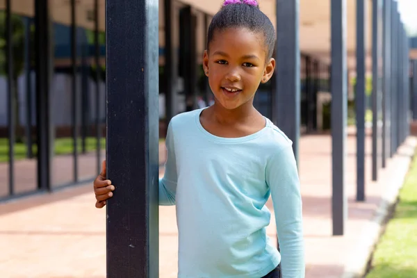 Portrait Happy Biracial Schoolgirl Smiling Holding Post Sunny Schoolyard Education — Stock Photo, Image