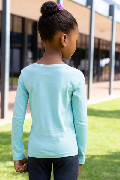 Rear View Biracial Schoolgirl Standing Sunny Schoolyard Education Inclusivity Childhood — Stock Photo, Image