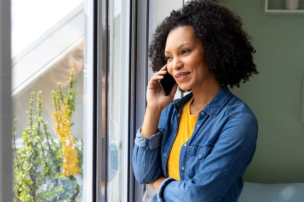 Happy Biracial Woman Talking Smartphone Looking Out Window Home Lifestyle — Stock Photo, Image