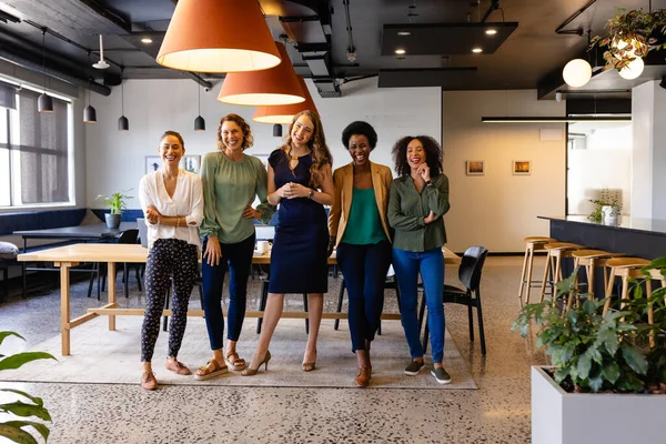 Stock image Portrait of happy diverse female colleagues in casual meeting in office. Casual office, teamwork, business and work, unaltered.