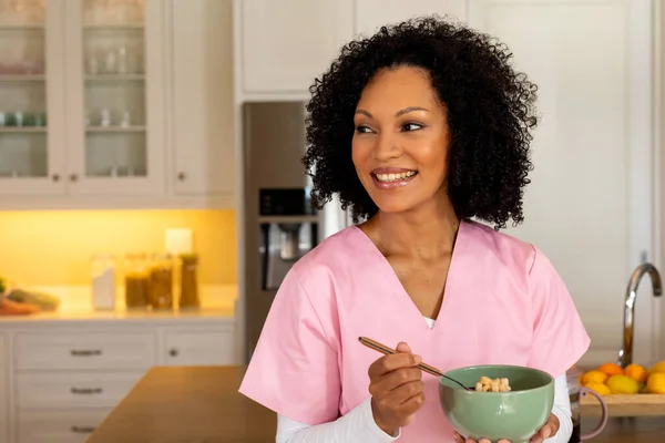 Happy Biracial Female Medical Worker Scrubs Eating Bowl Breakfast Cereal — Stock Photo, Image