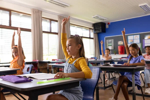 Разнообразные Ученики Начальной Школы Поднимают Руки Партами Классе Школа Обучение — стоковое фото