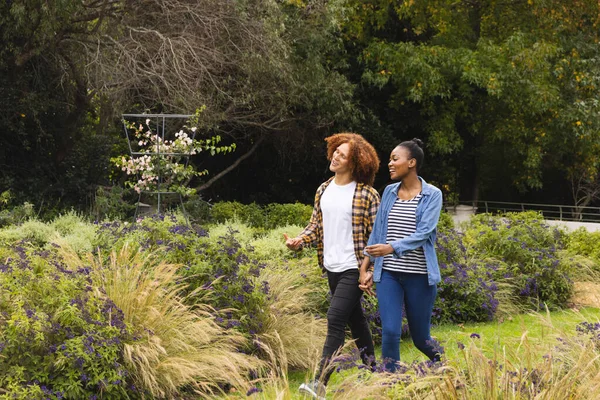 Happy Diverse Couple Holding Hands Walking Garden Talking Copy Space — Stock Photo, Image