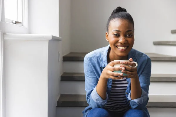Portrait Happy African American Woman Sitting Staircase Holding Coffee Smiling — Stock Photo, Image