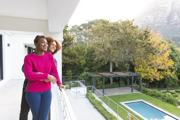 Happy Diverse Couple Embracing Standing Balcony Overlooking Garden Home Copy — Stock Photo, Image